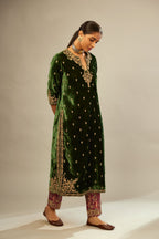 Green silk velvet kurta set with small embroidered zari buties all-over the kurta and detailed with dori embroidery at neck, sleeves, side slits and hem.