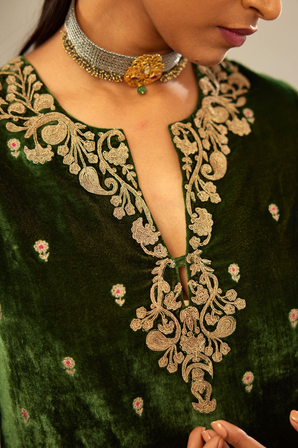 Green silk velvet kurta set with small embroidered zari buties all-over the kurta and detailed with dori embroidery at neck, sleeves, side slits and hem.