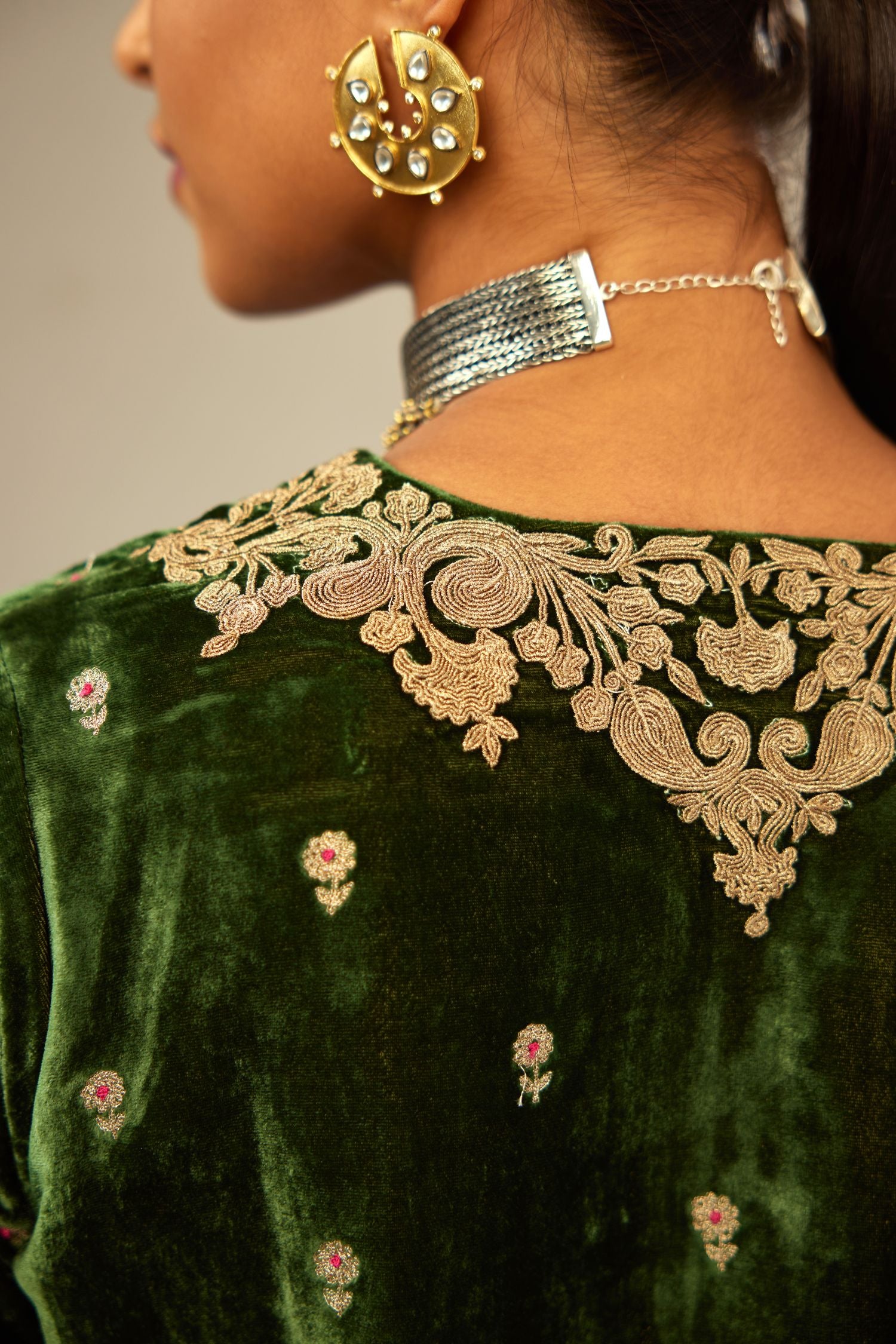 Green silk velvet kurta set with small embroidered zari buties all-over the kurta and detailed with dori embroidery at neck, sleeves, side slits and hem.