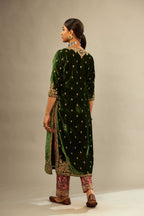 Green silk velvet kurta set with small embroidered zari buties all-over the kurta and detailed with dori embroidery at neck, sleeves, side slits and hem.