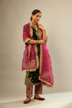 Green silk velvet kurta set with small embroidered zari buties all-over the kurta and detailed with dori embroidery at neck, sleeves, side slits and hem.