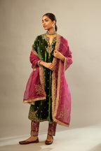 Green silk velvet kurta set with small embroidered zari buties all-over the kurta and detailed with dori embroidery at neck, sleeves, side slits and hem.