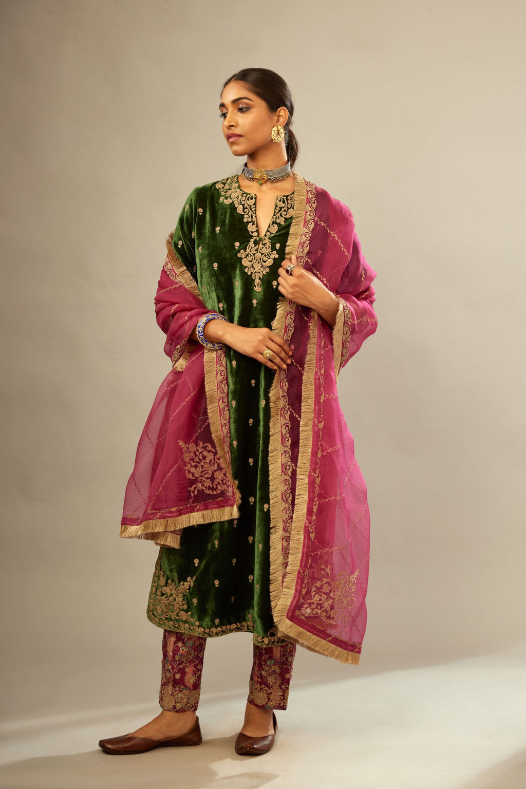 Green silk velvet kurta set with small embroidered zari buties all-over the kurta and detailed with dori embroidery at neck, sleeves, side slits and hem.