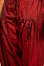 Maroon silk narrow salwar with light gold dori embroidery at hem.