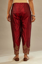 Maroon silk narrow salwar with light gold dori embroidery at hem.