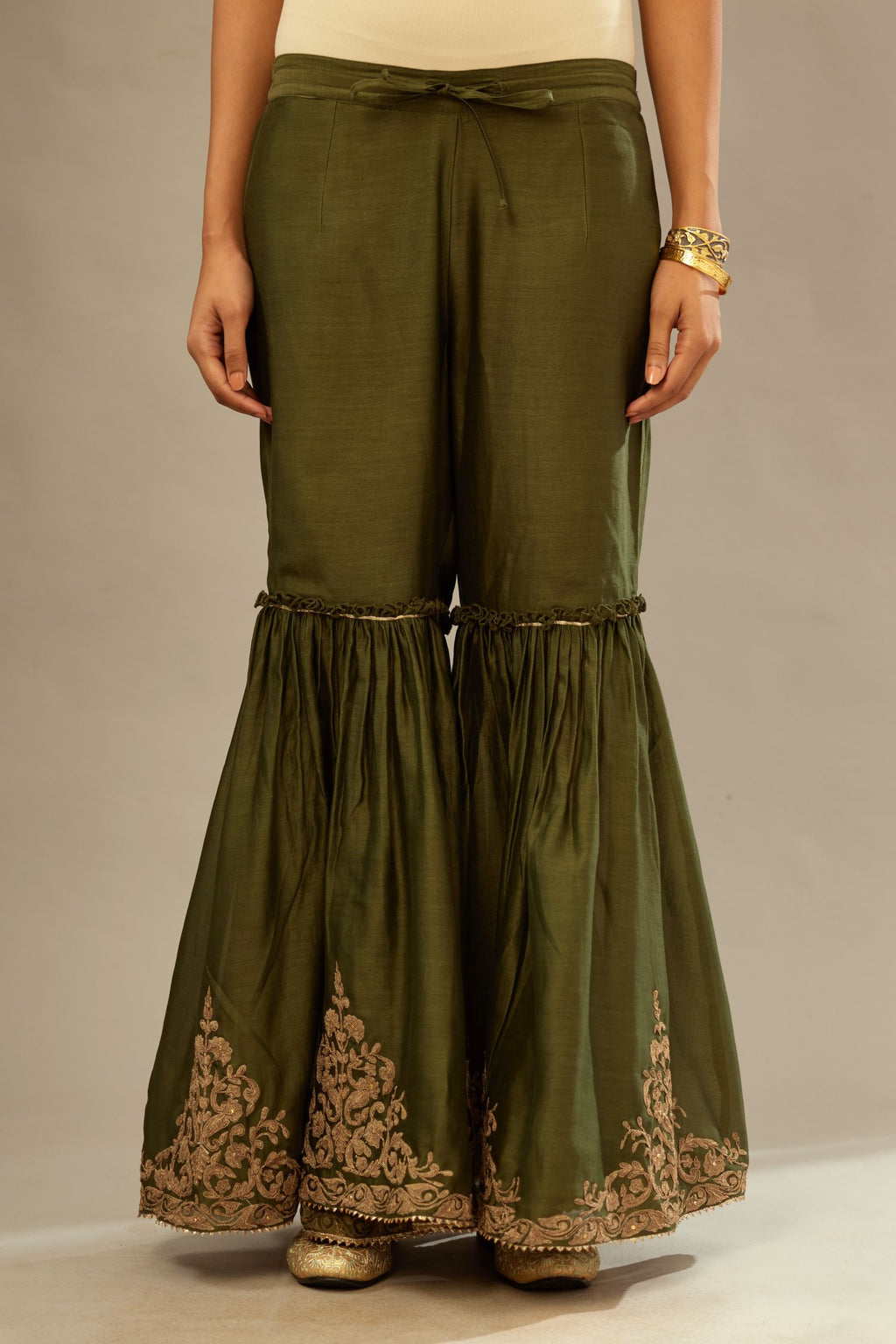 Olive silk chanderi farshi with gold dori embroidery and gota lace at hem.
