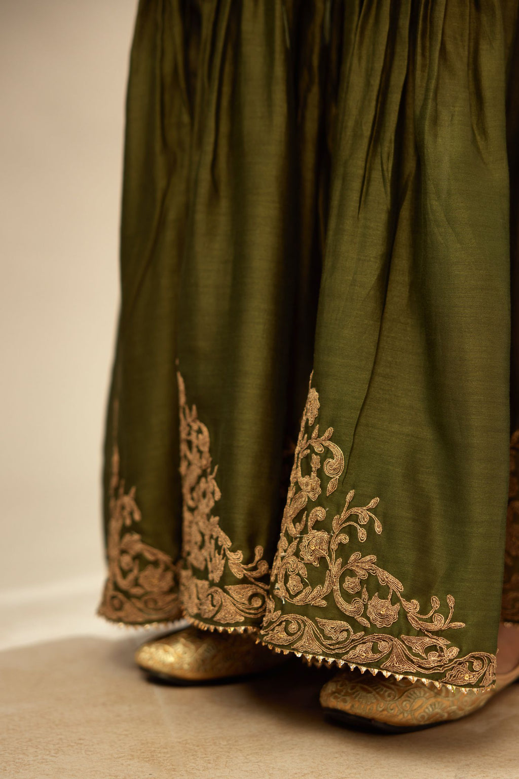 Olive silk chanderi farshi with gold dori embroidery and gota lace at hem.