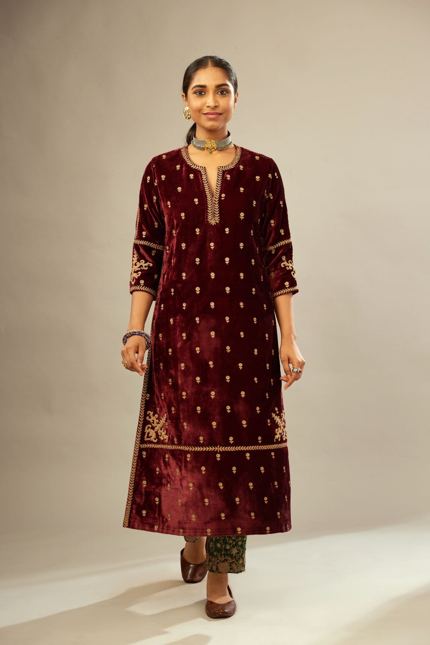Maroon silk velvet straight kurta set with small zari embroidered booti all-over the kurta, detailed with dori embroidery border at edges