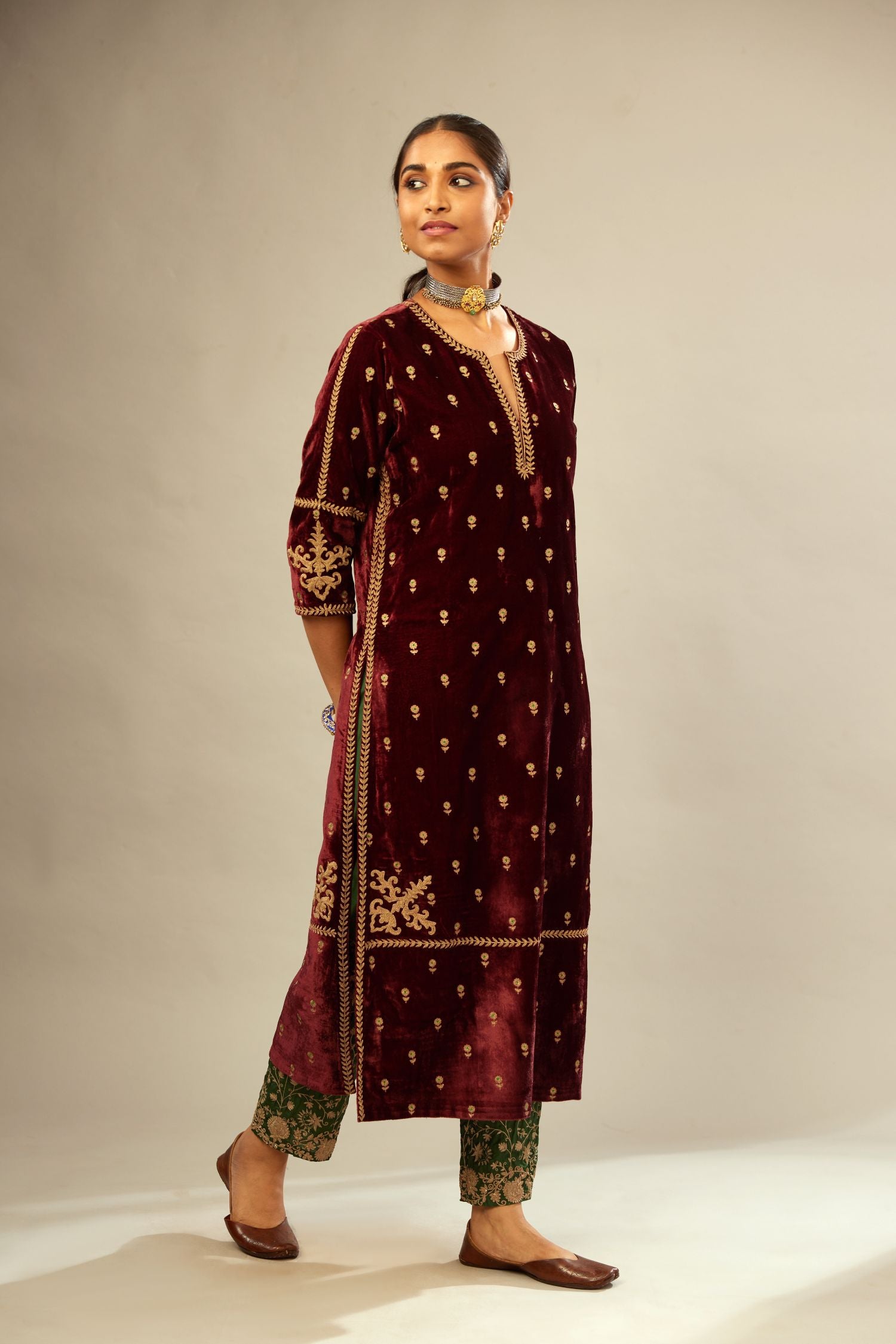 Maroon silk velvet straight kurta set with small zari embroidered booti all-over the kurta, detailed with dori embroidery border at edges