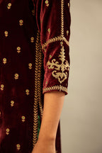 Maroon silk velvet straight kurta set with small zari embroidered booti all-over the kurta, detailed with dori embroidery border at edges