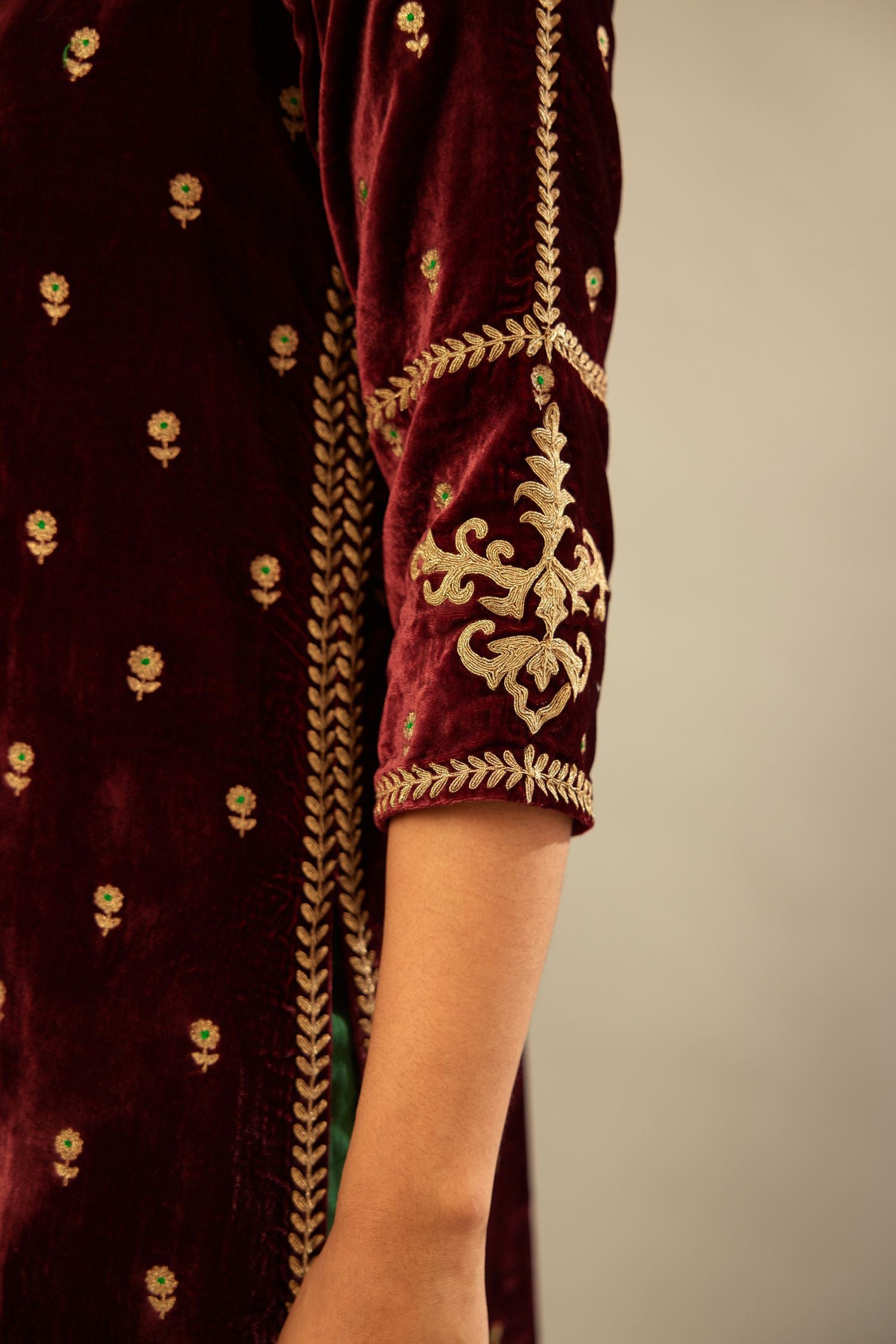 Maroon silk velvet straight kurta set with small zari embroidered booti all-over the kurta, detailed with dori embroidery border at edges