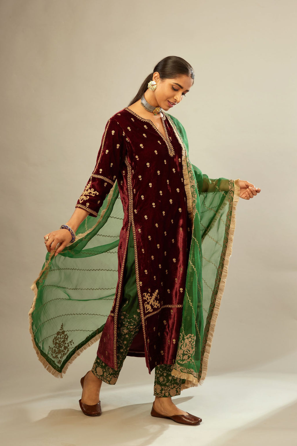Maroon silk velvet straight kurta set with small zari embroidered booti all-over the kurta, detailed with dori embroidery border at edges