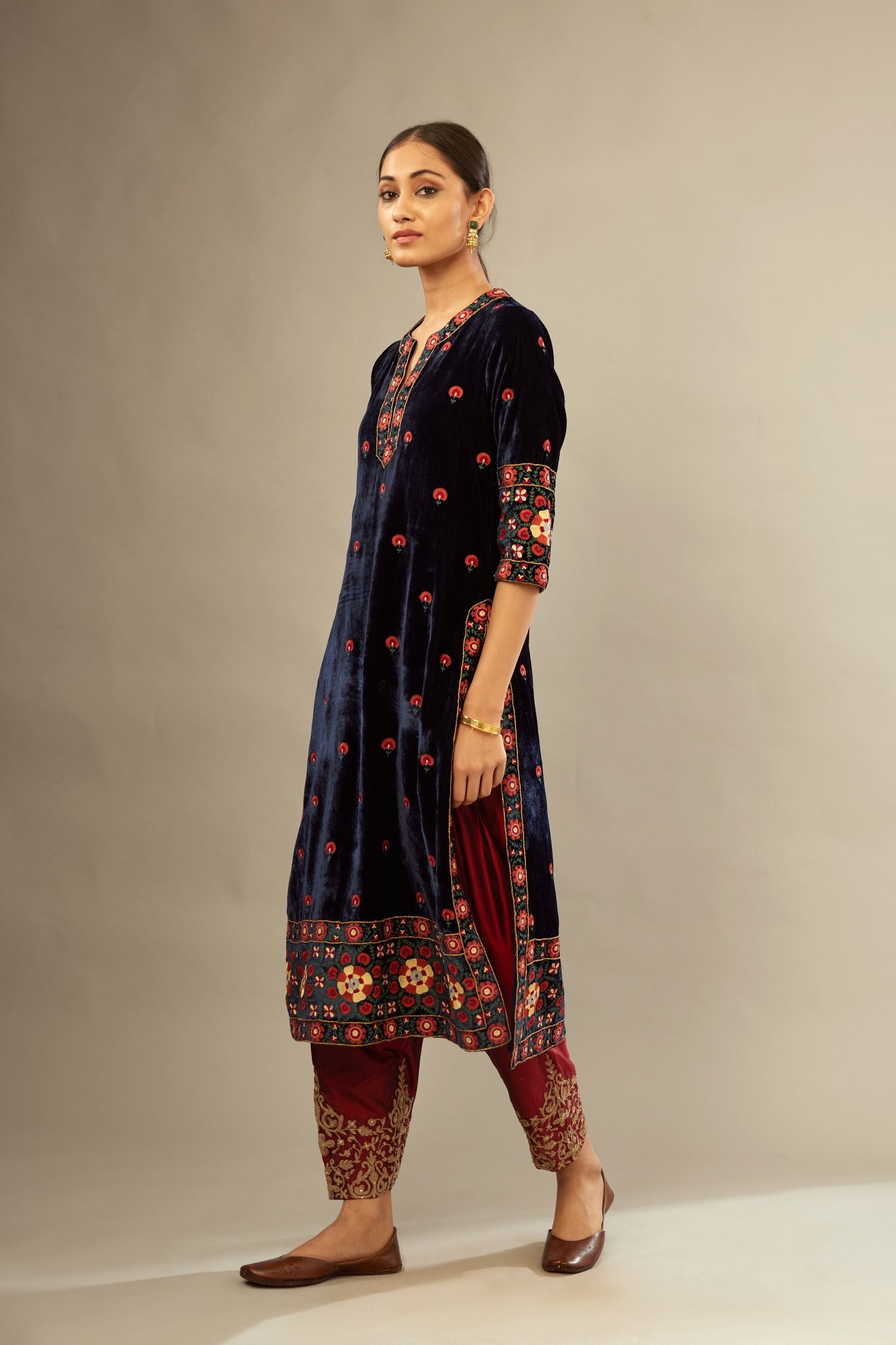 Navy blue silk velvet kurta set with multi colored big embroidered boota and border at hem, detailed with single zardosi work.