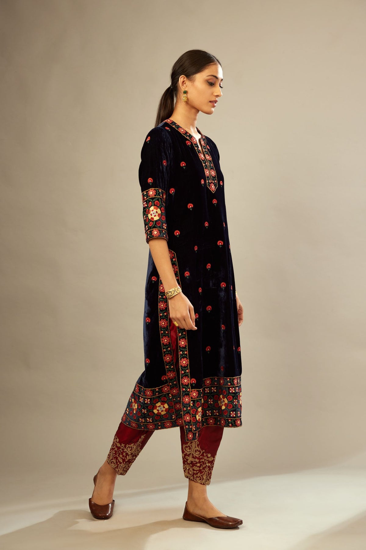 Navy blue silk velvet kurta set with multi colored big embroidered boota and border at hem, detailed with single zardosi work.