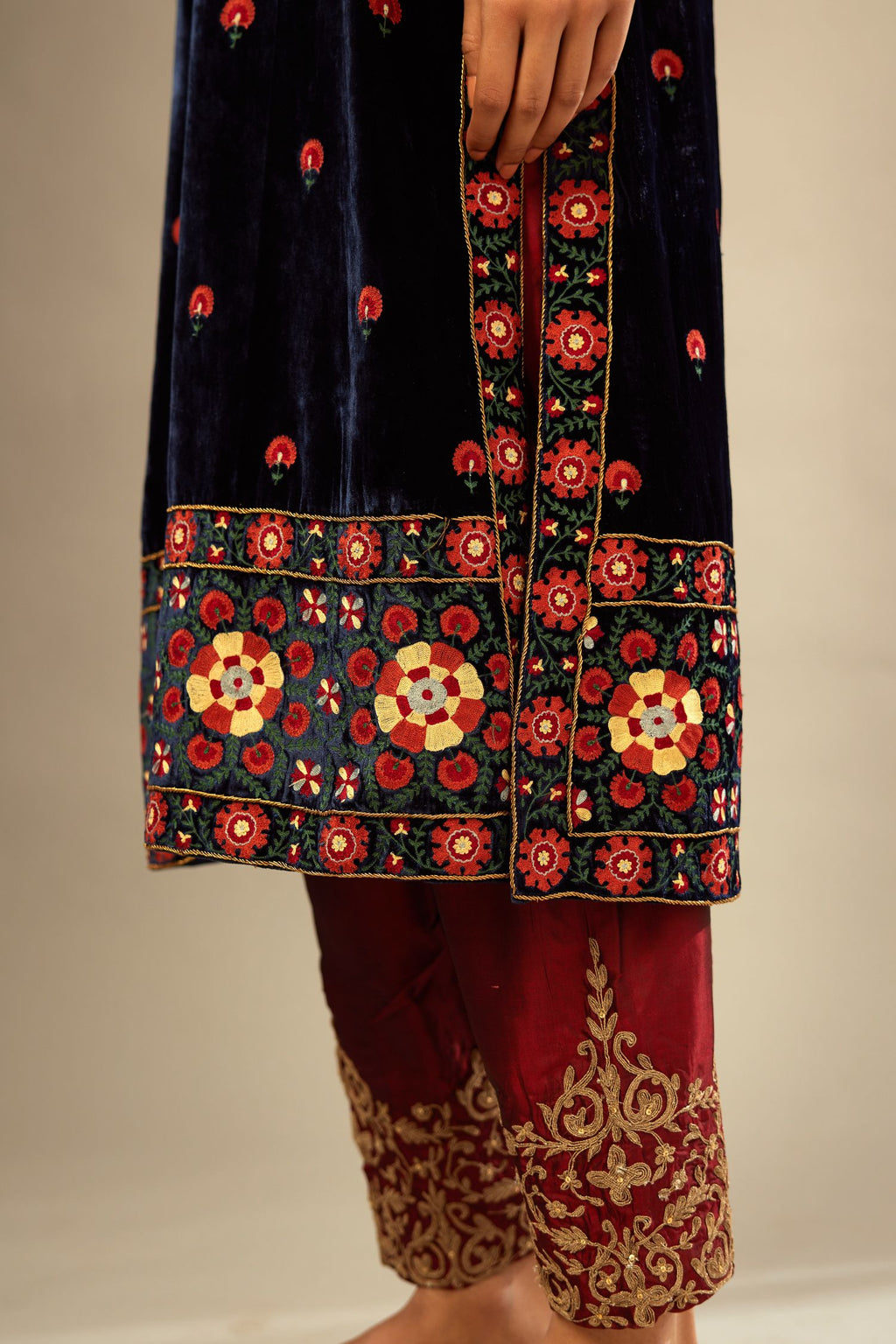 Navy blue silk velvet kurta set with multi colored big embroidered boota and border at hem, detailed with single zardosi work.