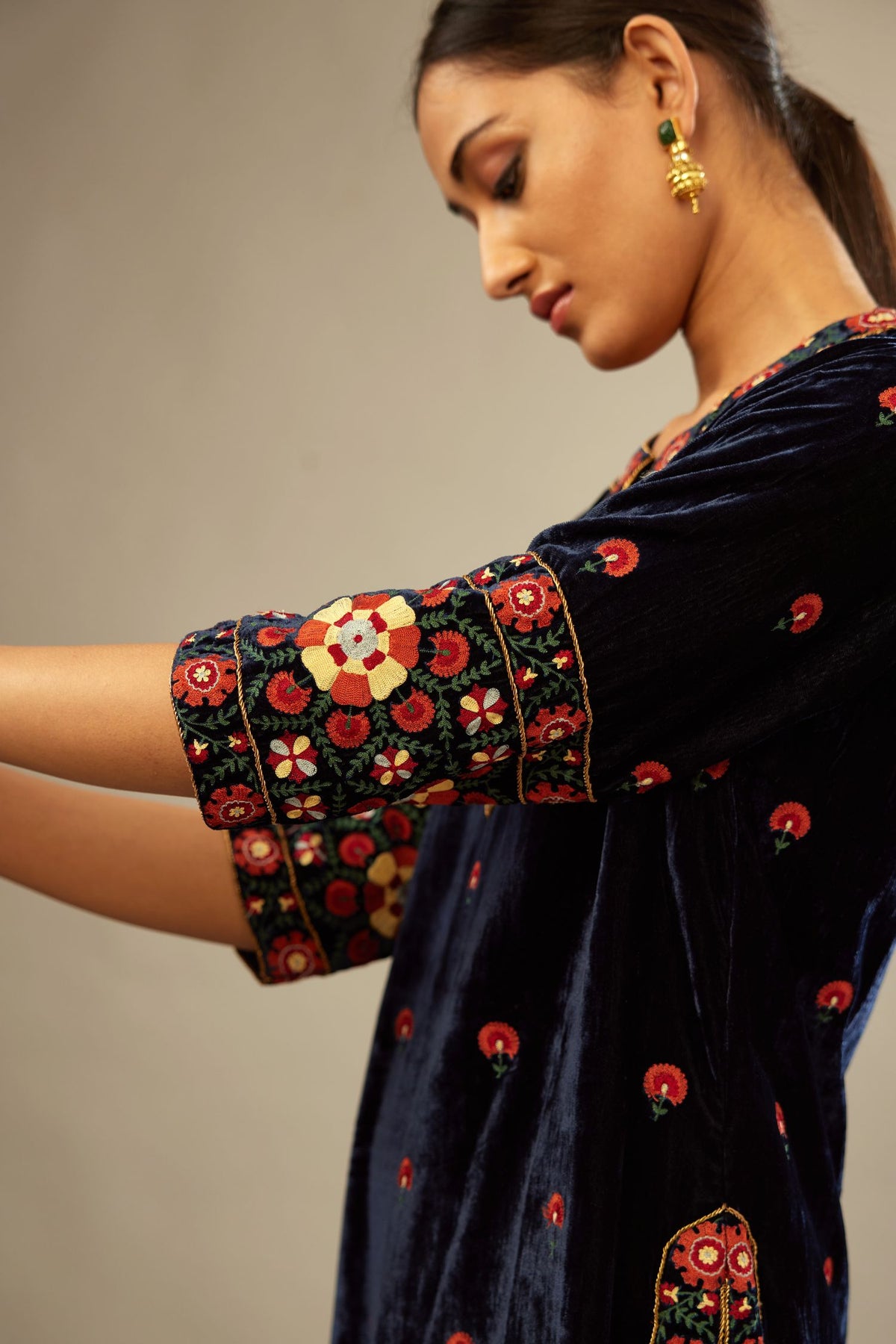 Navy blue silk velvet kurta set with multi colored big embroidered boota and border at hem, detailed with single zardosi work.