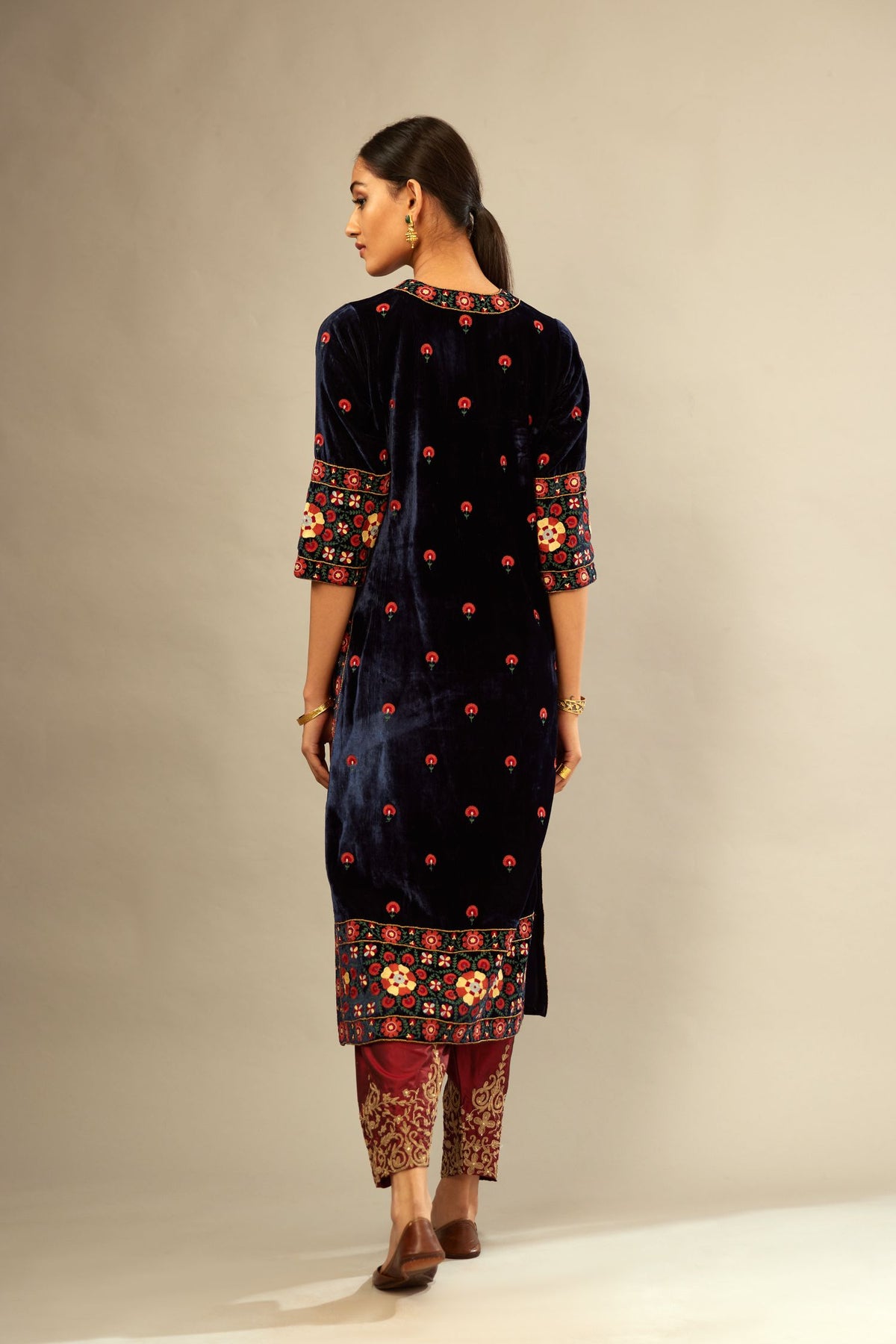 Navy blue silk velvet kurta set with multi colored big embroidered boota and border at hem, detailed with single zardosi work.