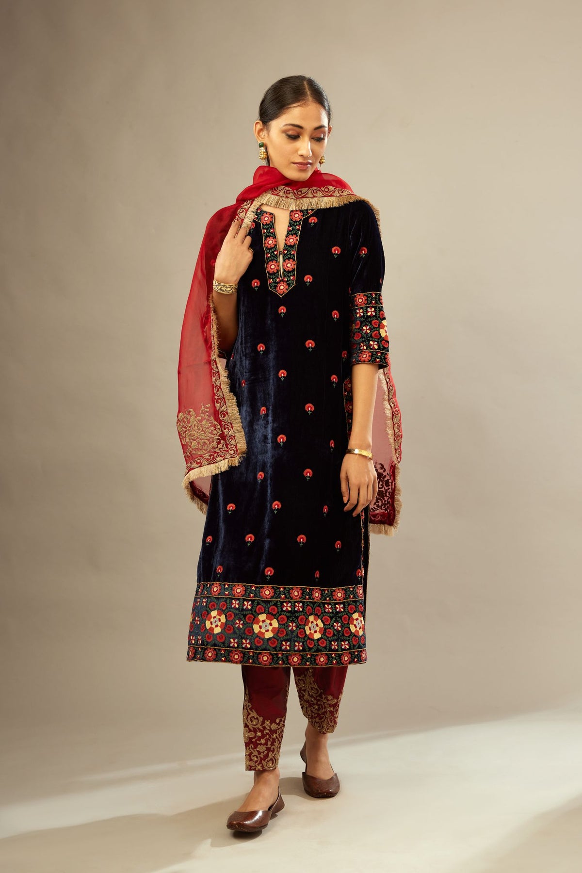 Navy blue silk velvet kurta set with multi colored big embroidered boota and border at hem, detailed with single zardosi work.