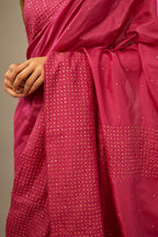 Jazzberry jam silk saree set with a broad border of hand embroidered geometrically aligned sequins and three horizontal bands at the pallu.