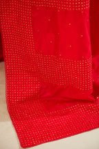 Red silk saree set with a broad border of hand embroidered geometrically aligned sequins and three horizontal bands at the pallu.