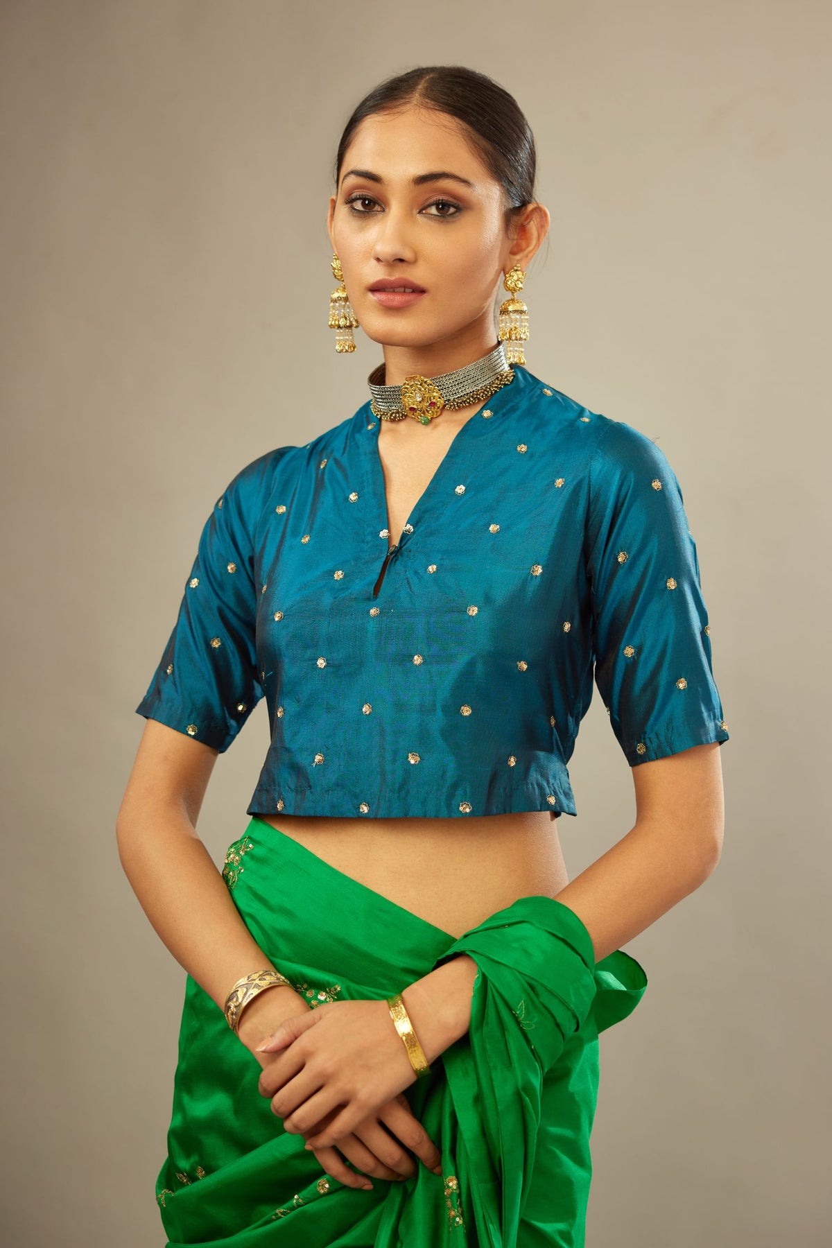 Dark teal silk easy fit blouse with a raised V neck and all-over delicate hand embroidered sequins flowers.
