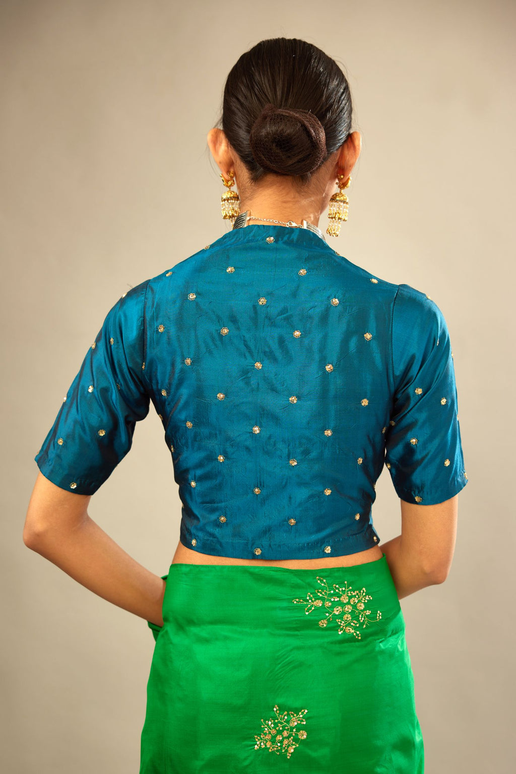 Dark teal silk easy fit blouse with a raised V neck and all-over delicate hand embroidered sequins flowers.