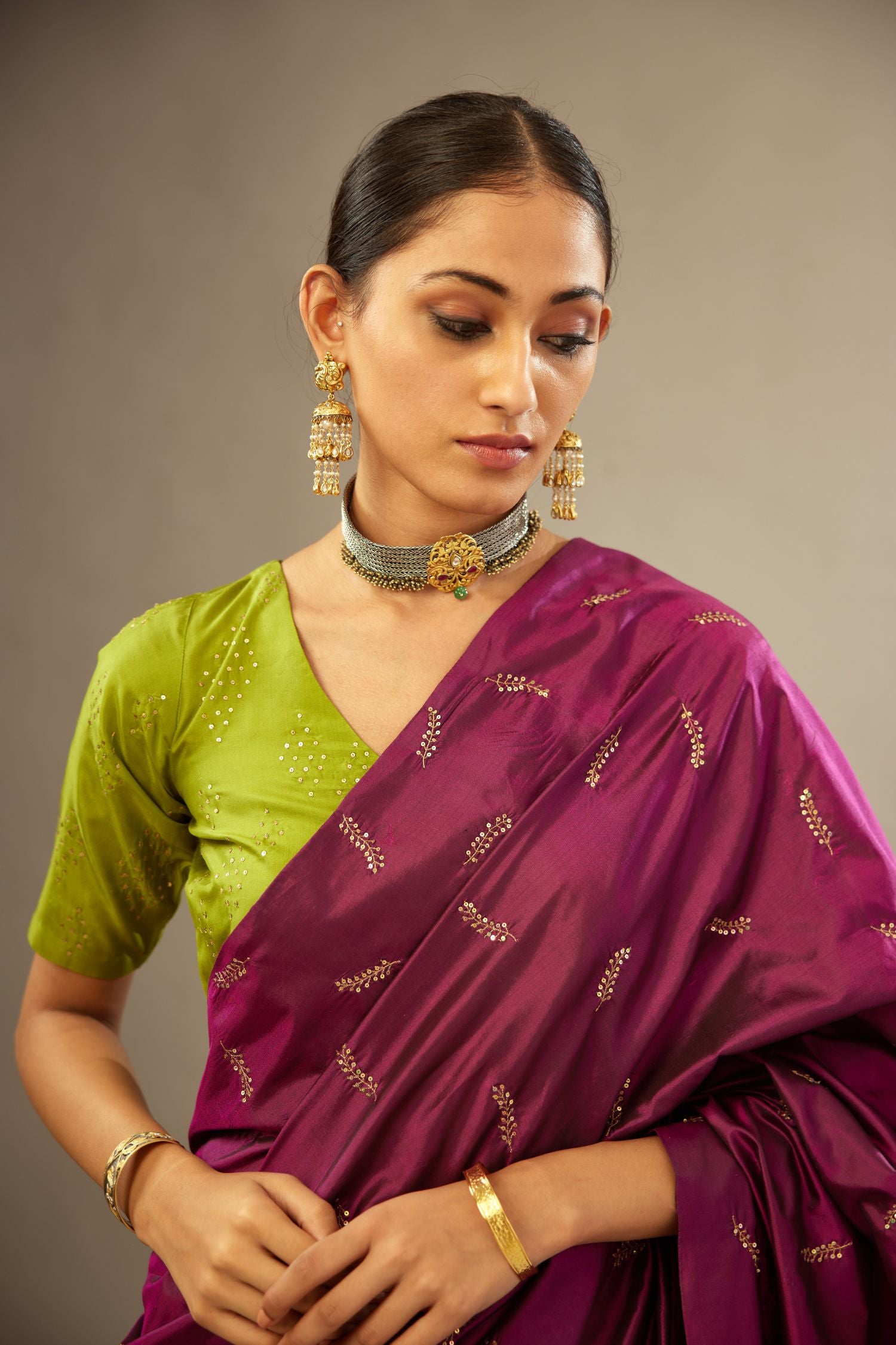 Apple green V neck silk easy fit blouse with a side zip and hand embroidered diamond motifs in fine sequins all over the body.