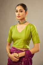 Apple green V neck silk easy fit blouse with a side zip and hand embroidered diamond motifs in fine sequins all over the body.