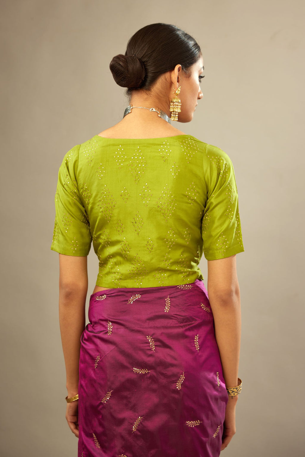 Apple green V neck silk easy fit blouse with a side zip and hand embroidered diamond motifs in fine sequins all over the body.