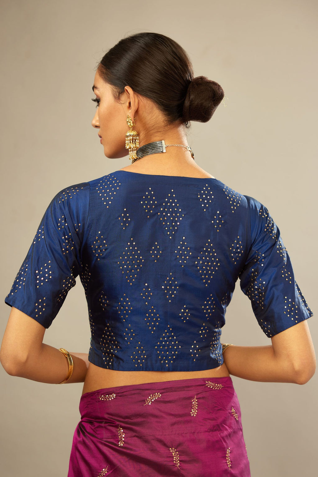 Navy blue V neck silk easy fit blouse with a side zip and hand embroidered diamond motifs in fine sequins all over the body.