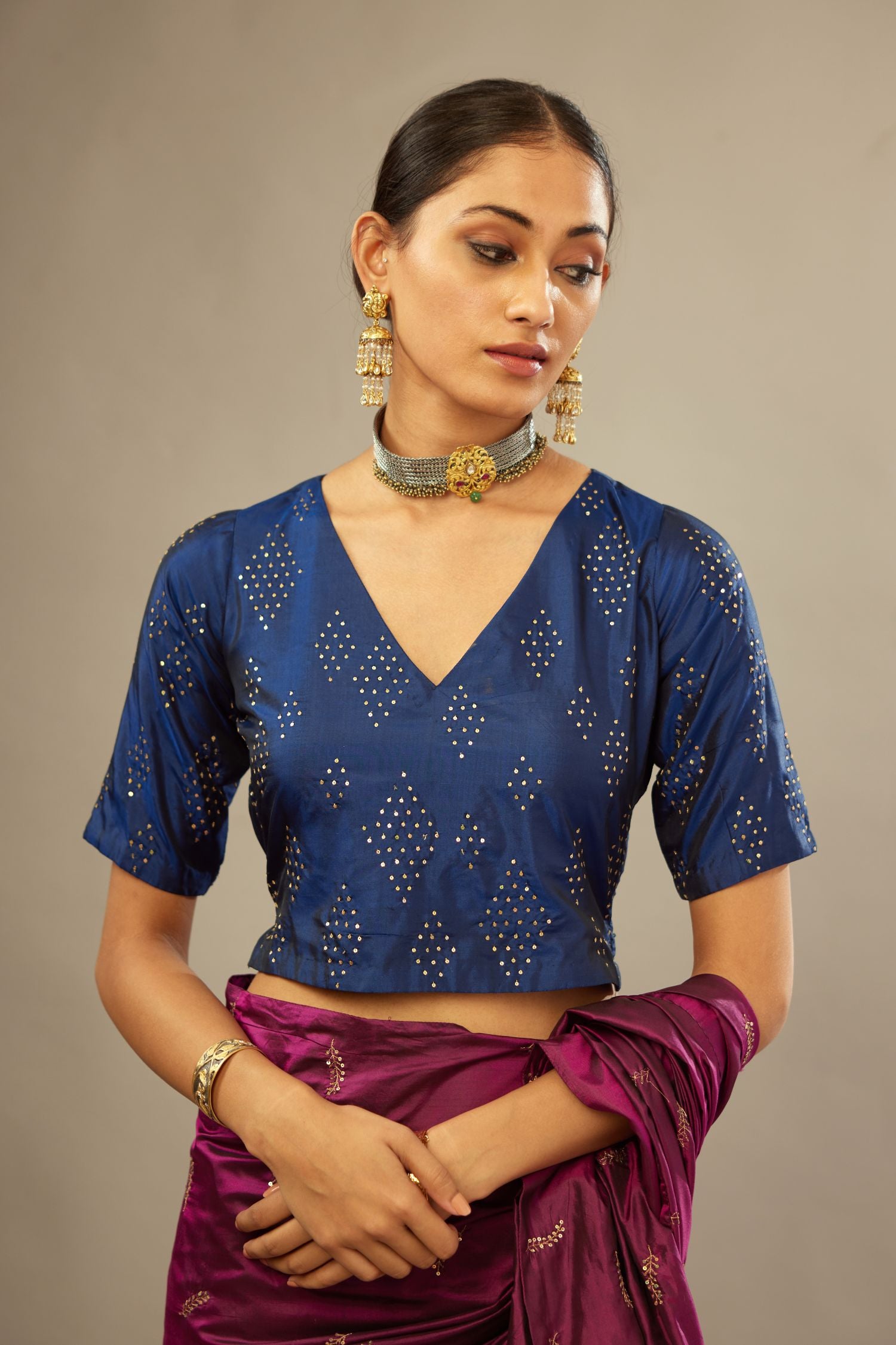 Navy blue V neck silk easy fit blouse with a side zip and hand embroidered diamond motifs in fine sequins all over the body.