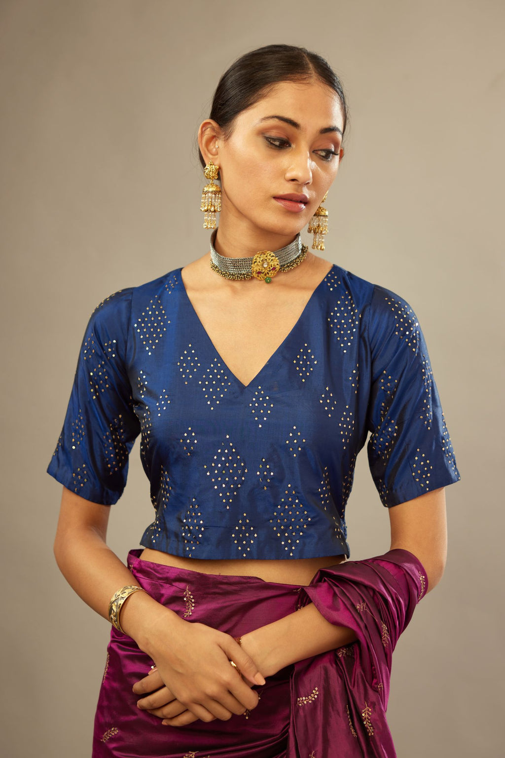 Navy blue V neck silk easy fit blouse with a side zip and hand embroidered diamond motifs in fine sequins all over the body.