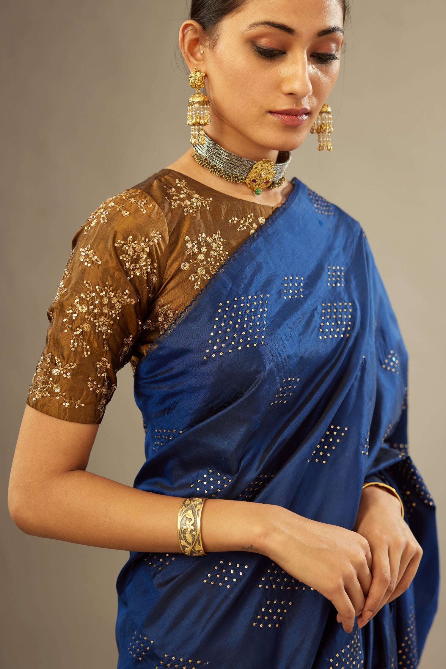 Golden olive jewel neck easy fit blouse with a side zip opening and fully covered with hand embroidered delicate sequins butas in light gold.