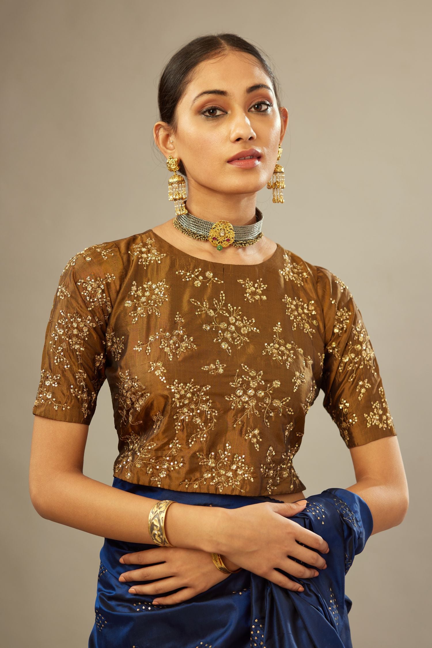 Golden olive jewel neck easy fit blouse with a side zip opening and fully covered with hand embroidered delicate sequins butas in light gold.