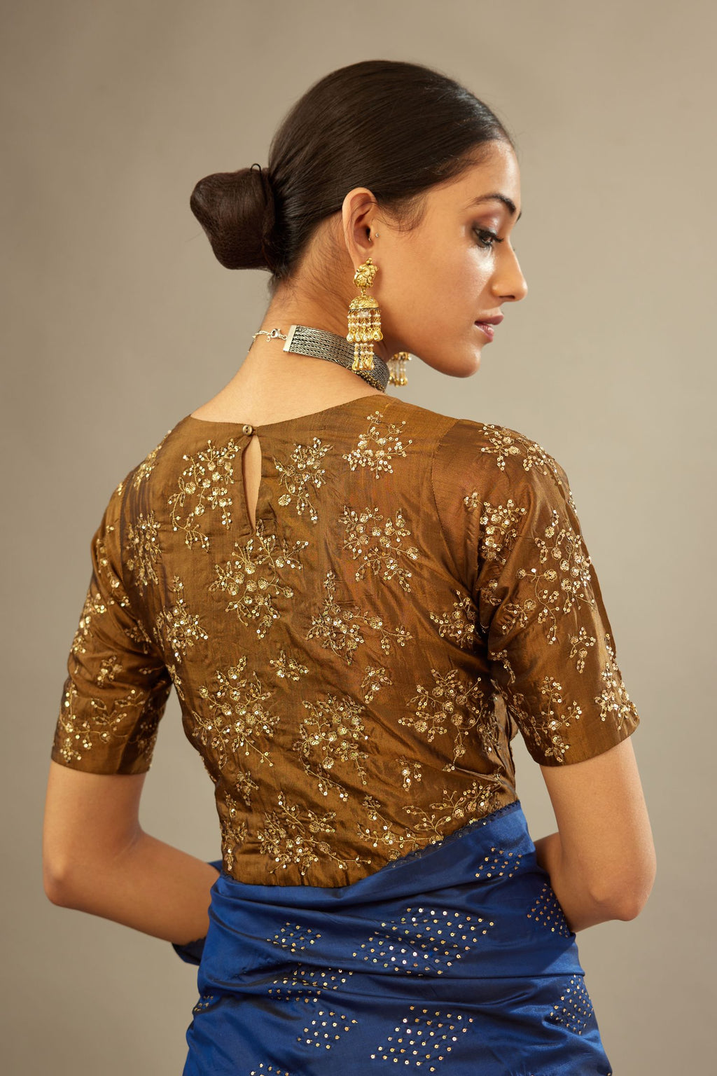Golden olive jewel neck easy fit blouse with a side zip opening and fully covered with hand embroidered delicate sequins butas in light gold.