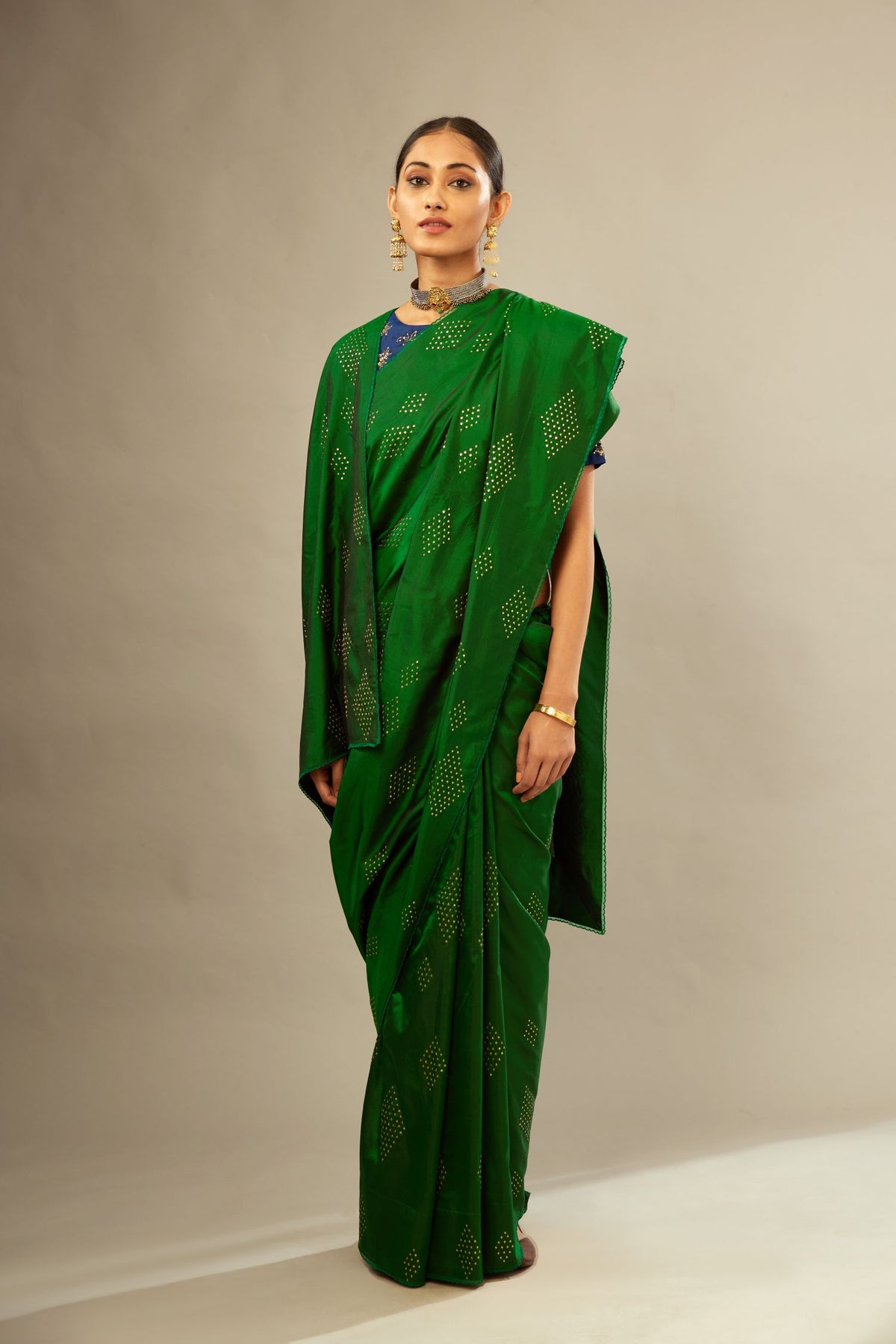 Dark green silk saree set with all over hand embroidered geometric diamond motifs in sequins.