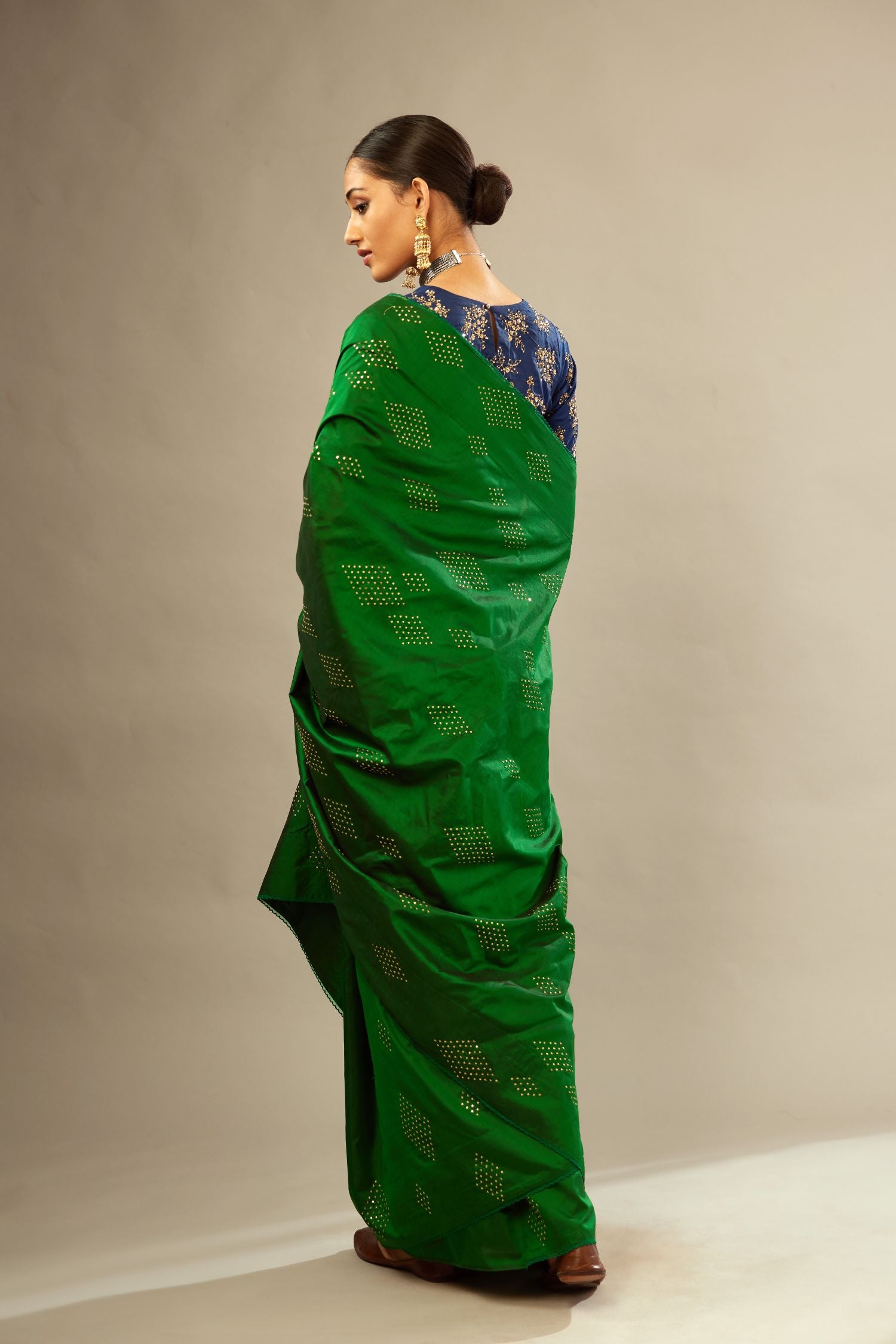 Dark green silk saree set with all over hand embroidered geometric diamond motifs in sequins.