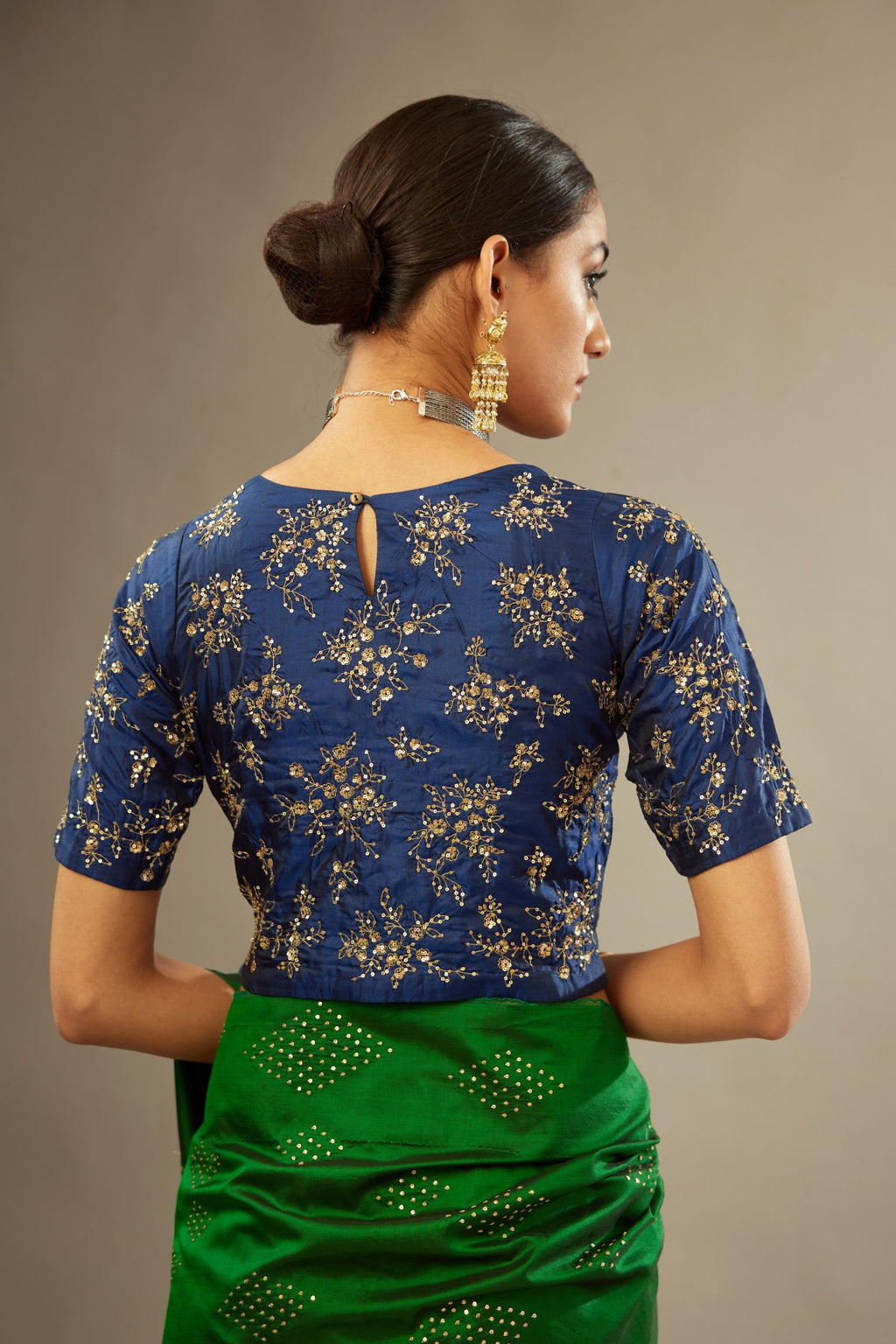 Navy blue jewel neck easy fit blouse with a side zip opening and fully covered with hand embroidered delicate sequins butas in light gold.