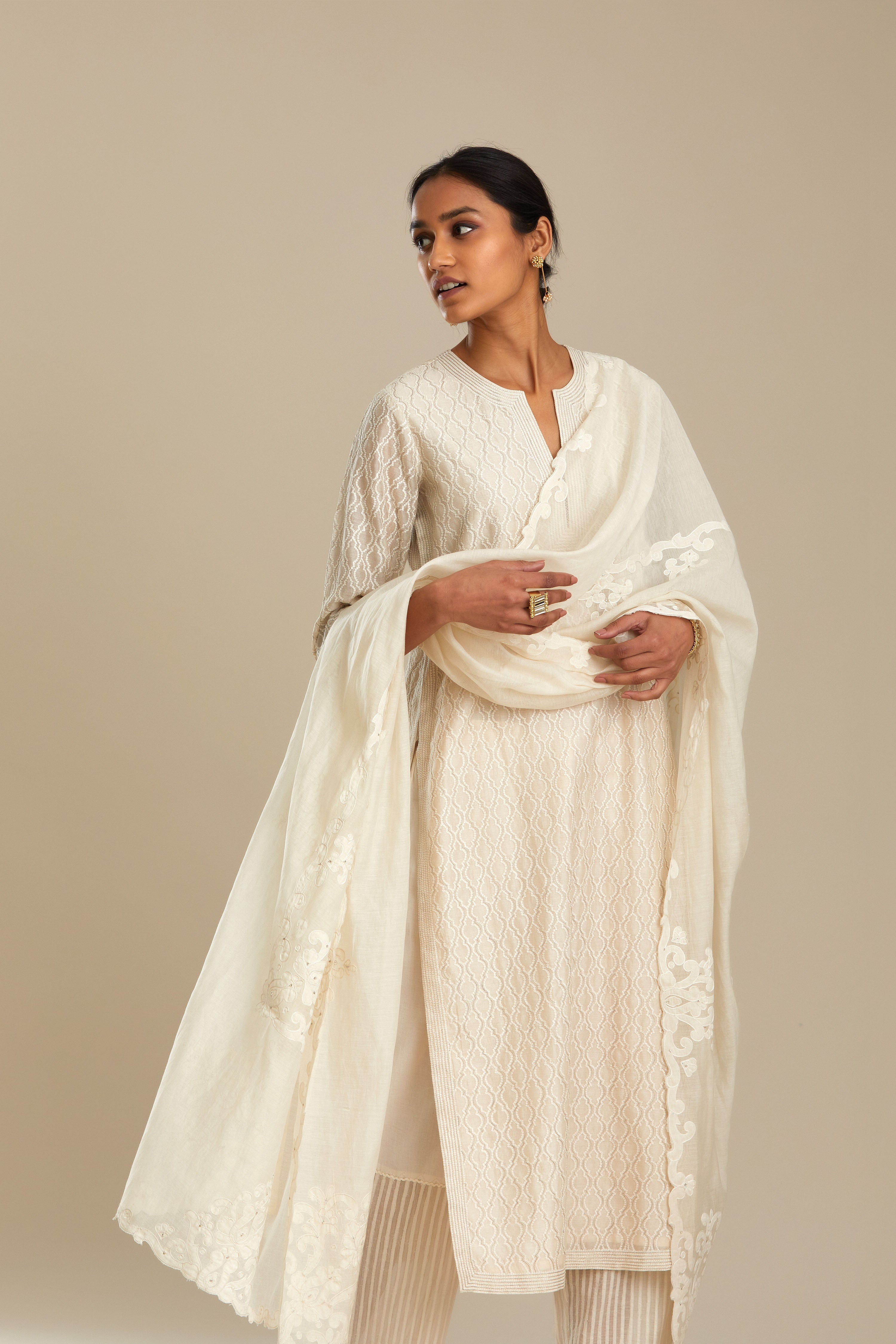 Off white silk chanderi straight kurta set with all-over jharoka jaal embroidery.