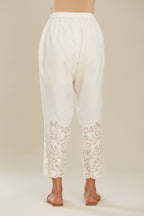 Off white cotton narrow pants with appliqué and hand attached sequins detailing. (Pants)