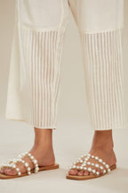 Off white cotton straight pants with striped appliqué till mid calf length. (Pants)