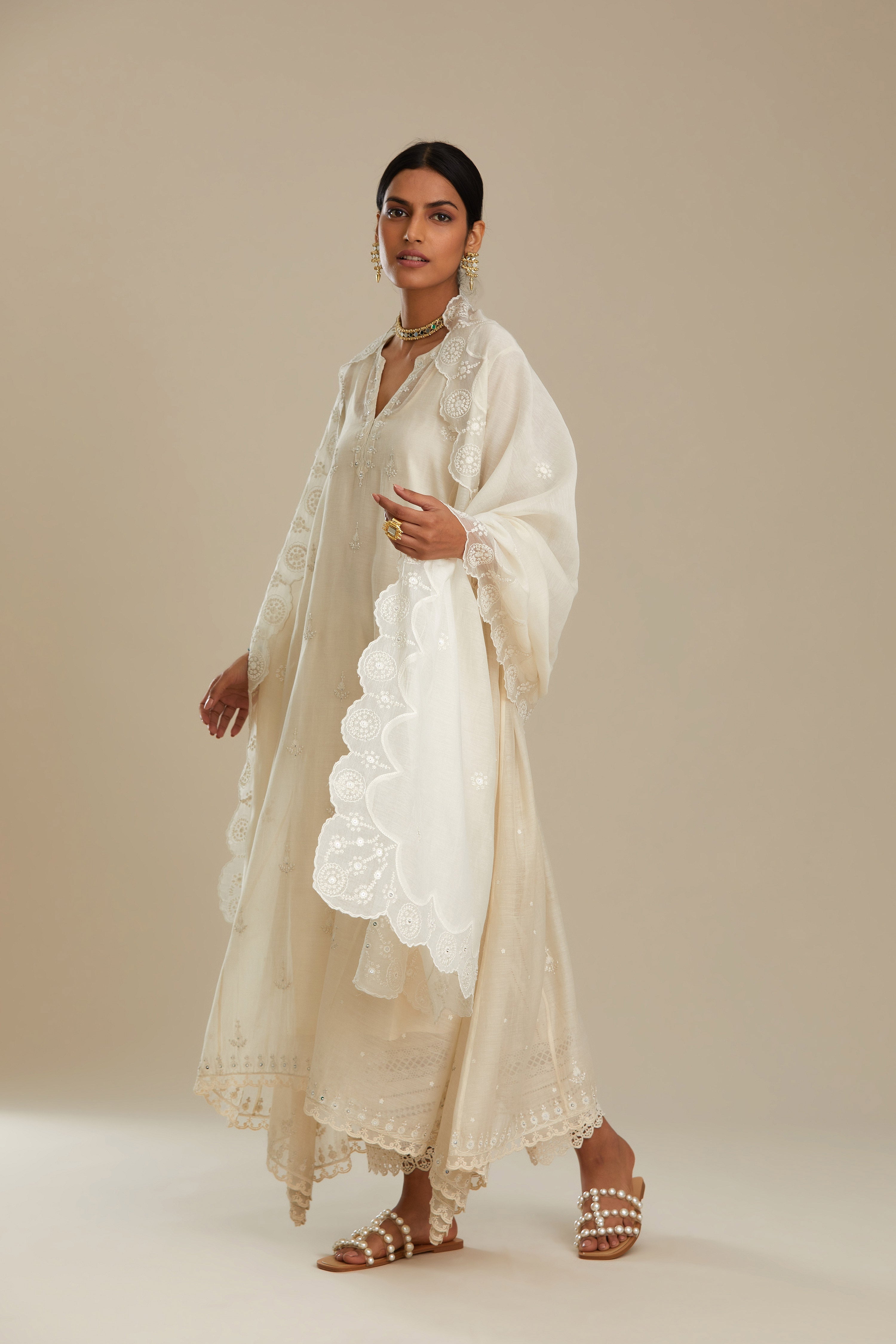 Off white cotton Chanderi kurta set with asymmetric hem, highlighted with sequins, beads and lace.