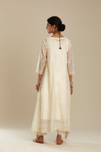 Off white cotton Chanderi kurta set with asymmetric hem, highlighted with sequins, beads and lace.