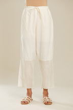 Off white cotton straight pants with striped appliqué till mid calf length. (Pants)