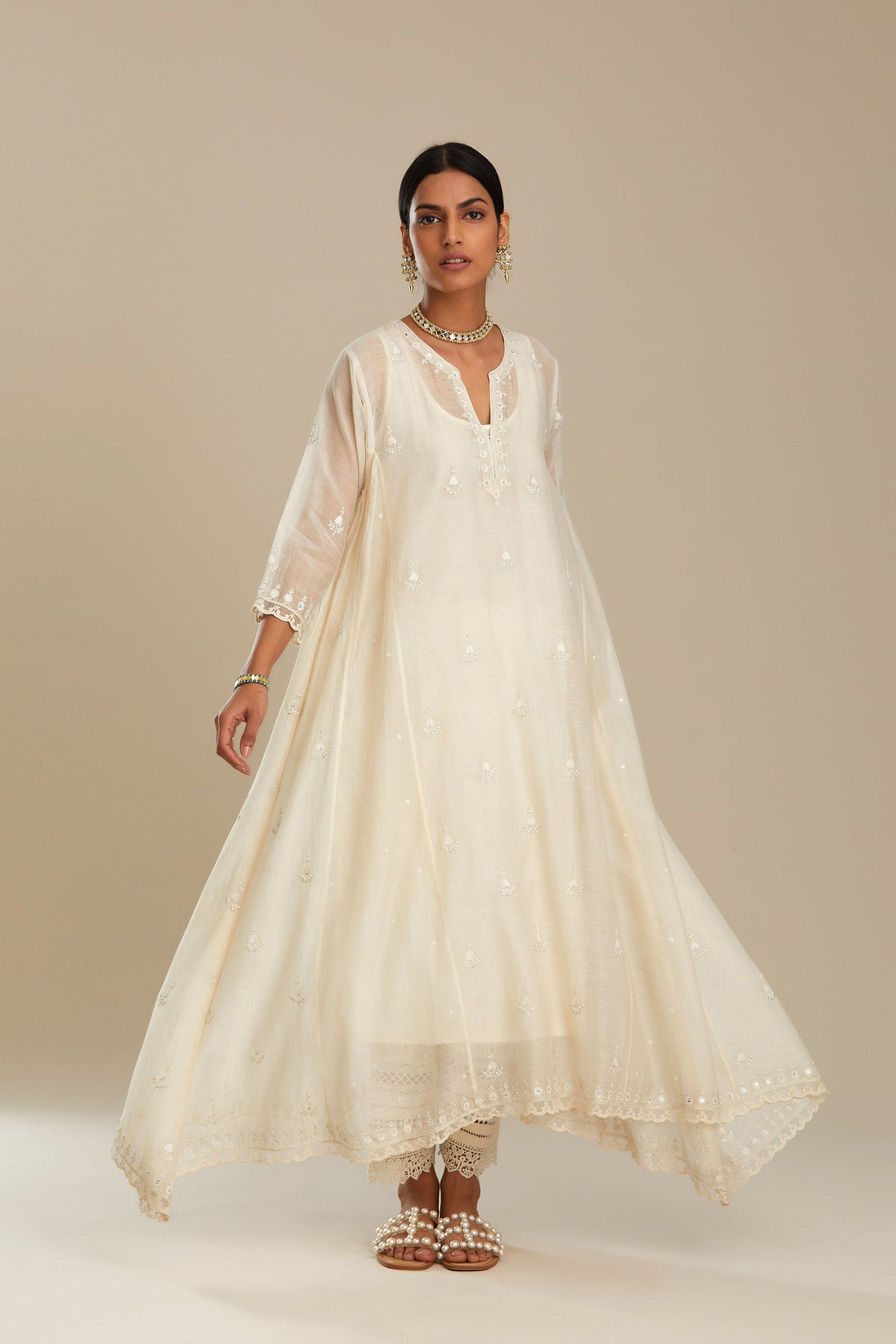 Off white cotton Chanderi kurta set with asymmetric hem, highlighted with sequins, beads and lace.
