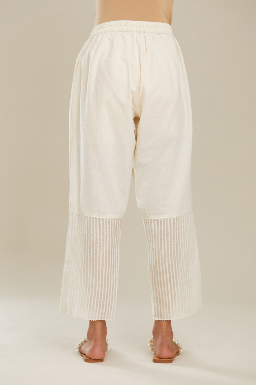 Off white cotton straight pants with striped appliqué till mid calf length. (Pants)