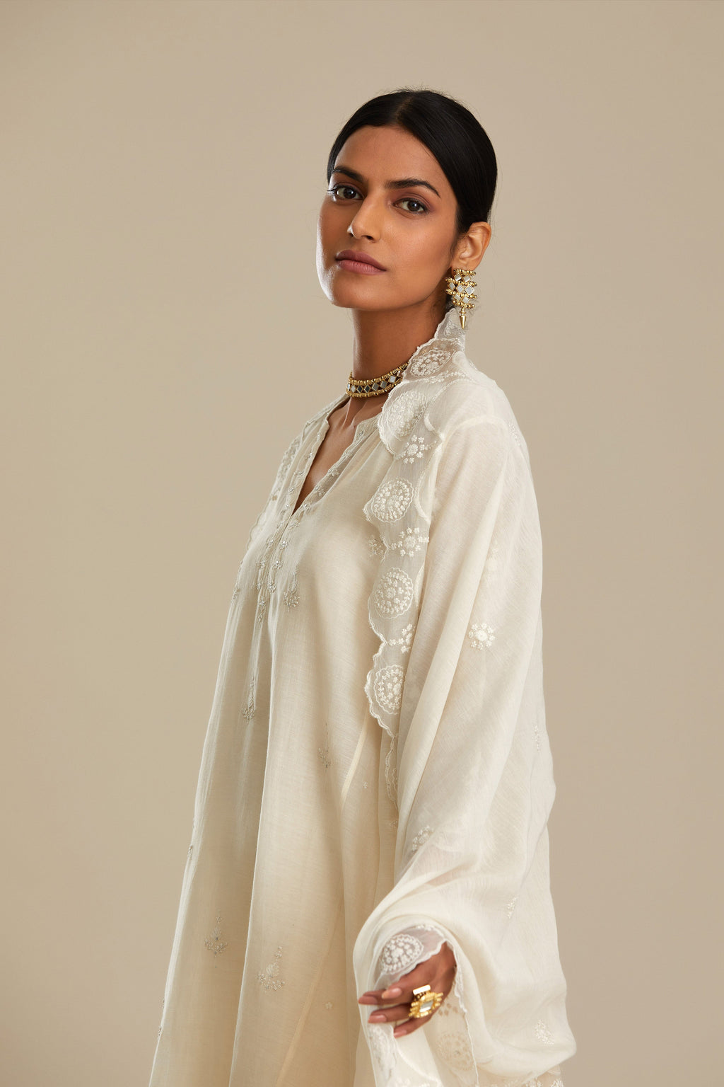 Off white cotton Chanderi kurta set with asymmetric hem, highlighted with sequins, beads and lace.