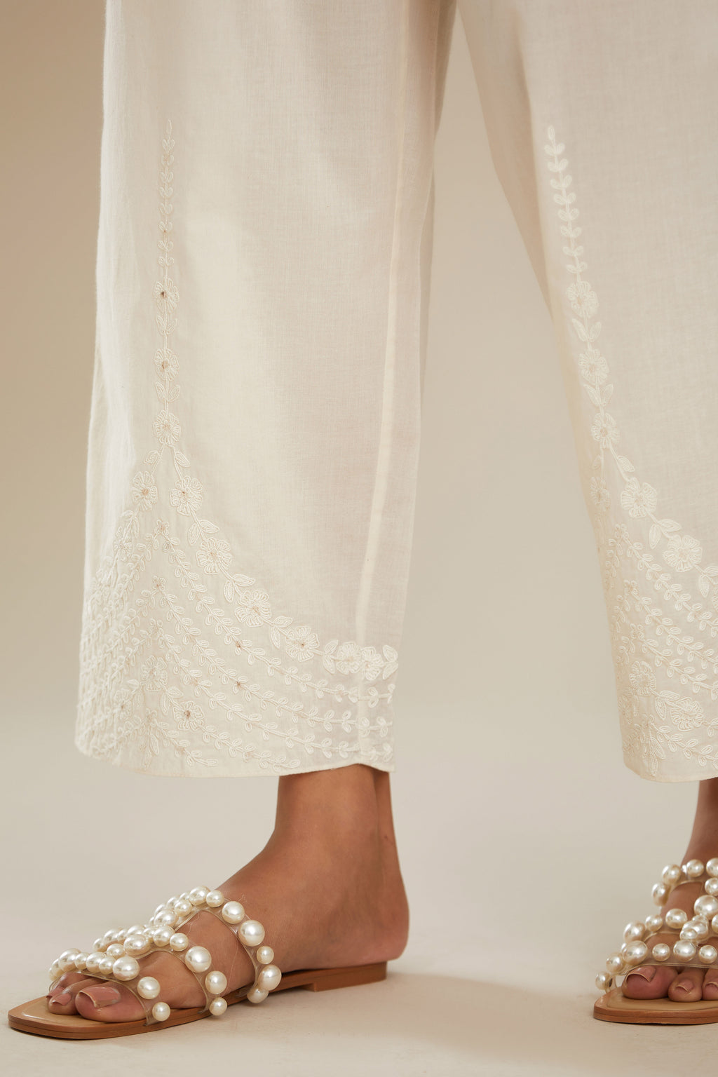 Off white cotton straight pants with dori embroidery at hem. (Pants)