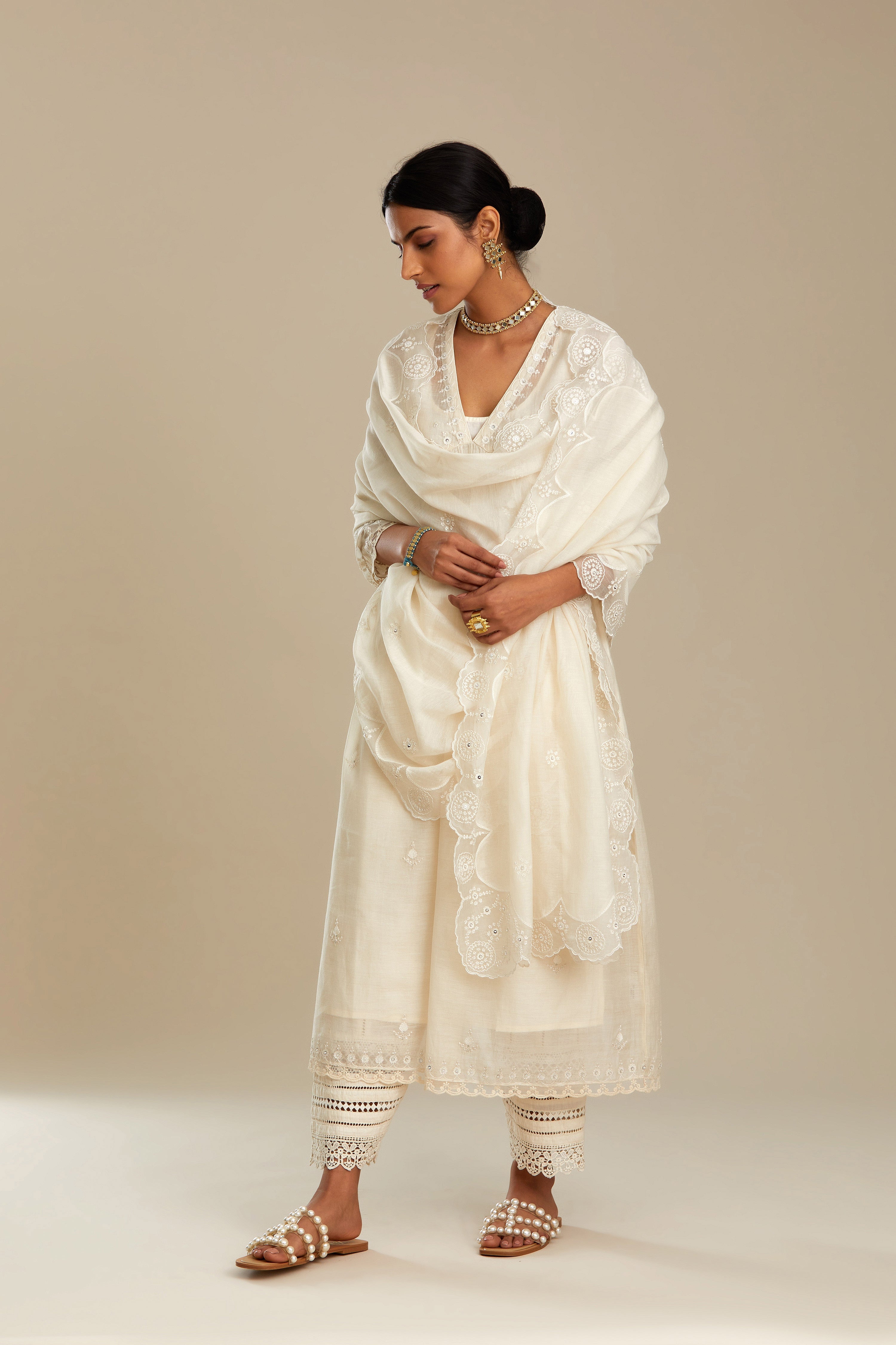 Off white cotton chanderi kurta set with tonal silk thread embroidery highlighted with sequins and beads.