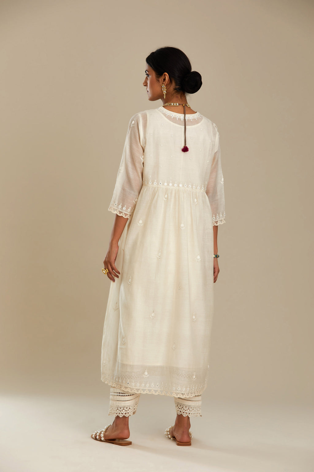 Off white cotton chanderi kurta set with tonal silk thread embroidery highlighted with sequins and beads.